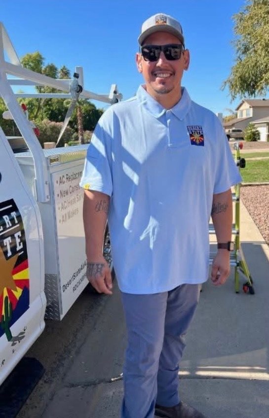 Javi Rios, lead installer at Desert State Air, standing beside a company service truck