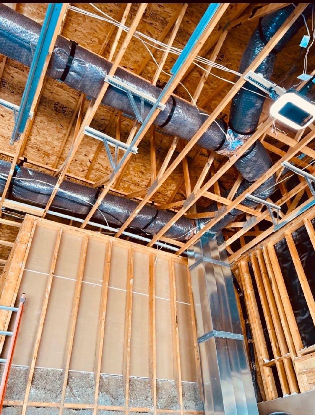 Insulated ductwork hung in open framing on a new build